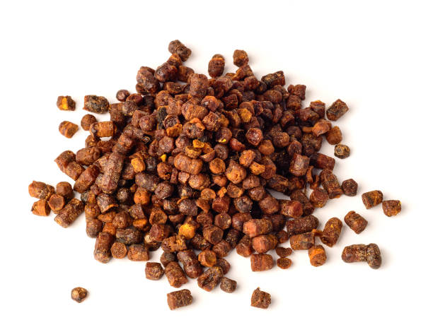 Granules of bee bread isolated on a white background.