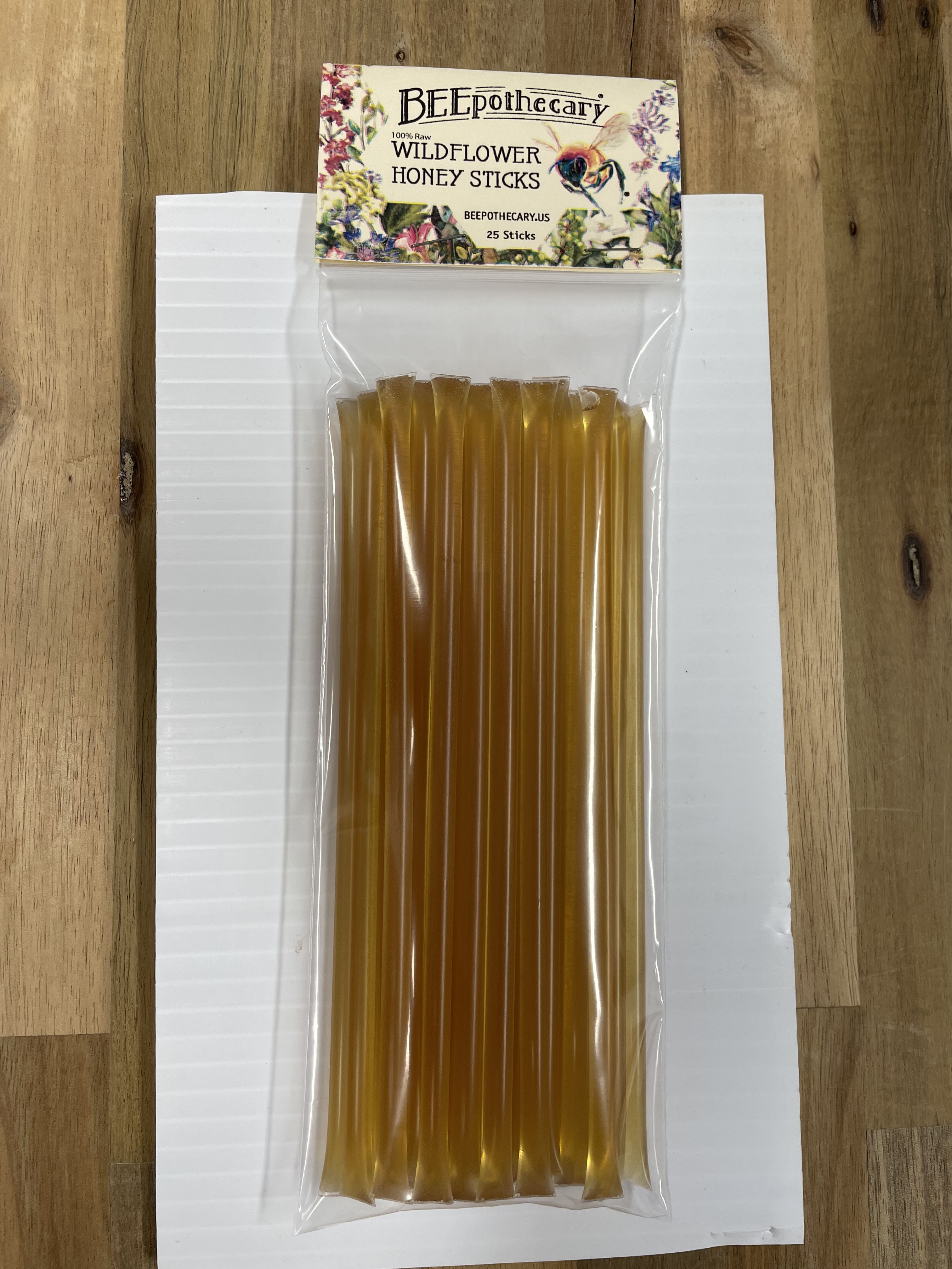 BEEpothecary Wildflower honey stick in 25 count clear packaging. Honey is deep golden color.