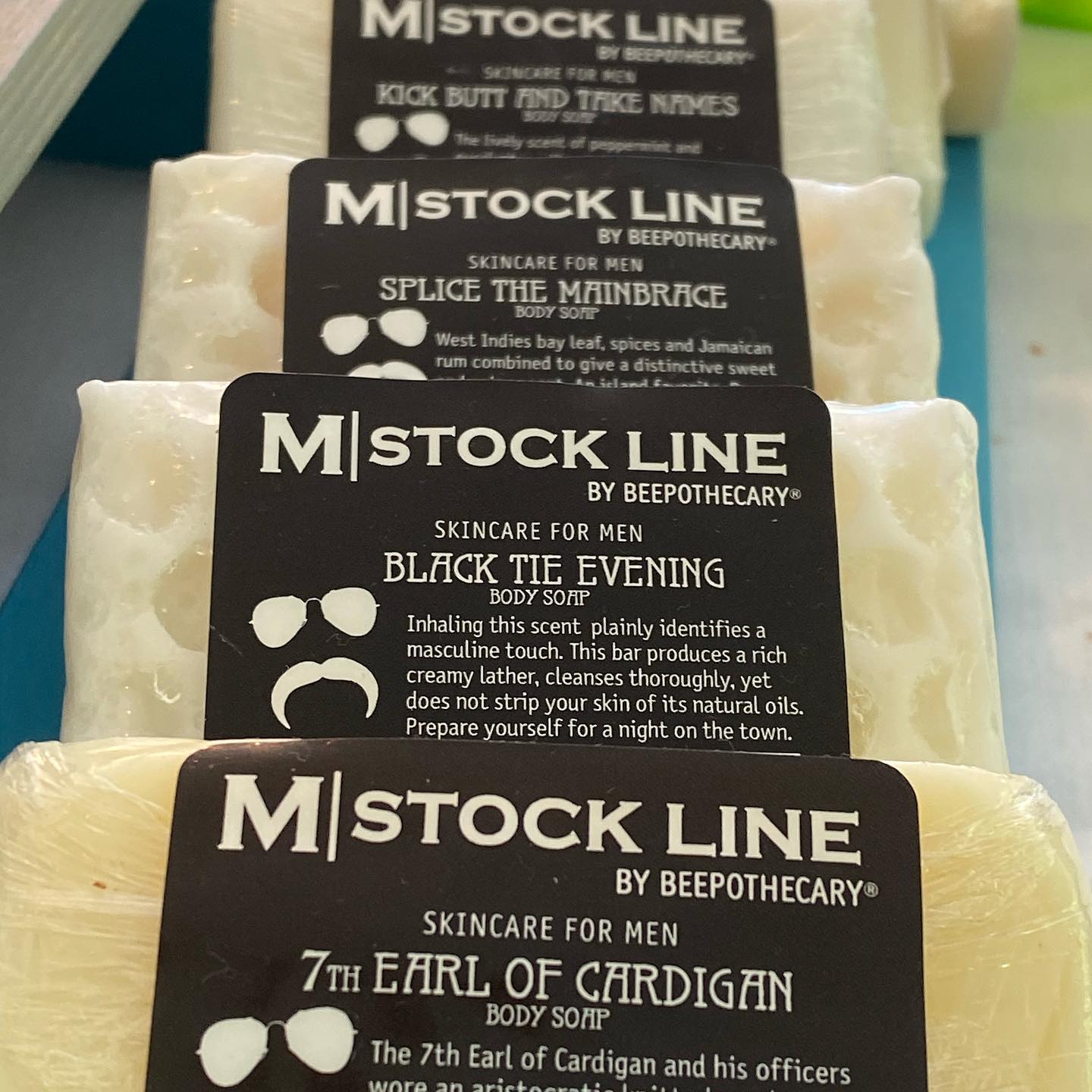 Line of BEEpothecary Goat Milk Soaps. Soaps are white with a black label.