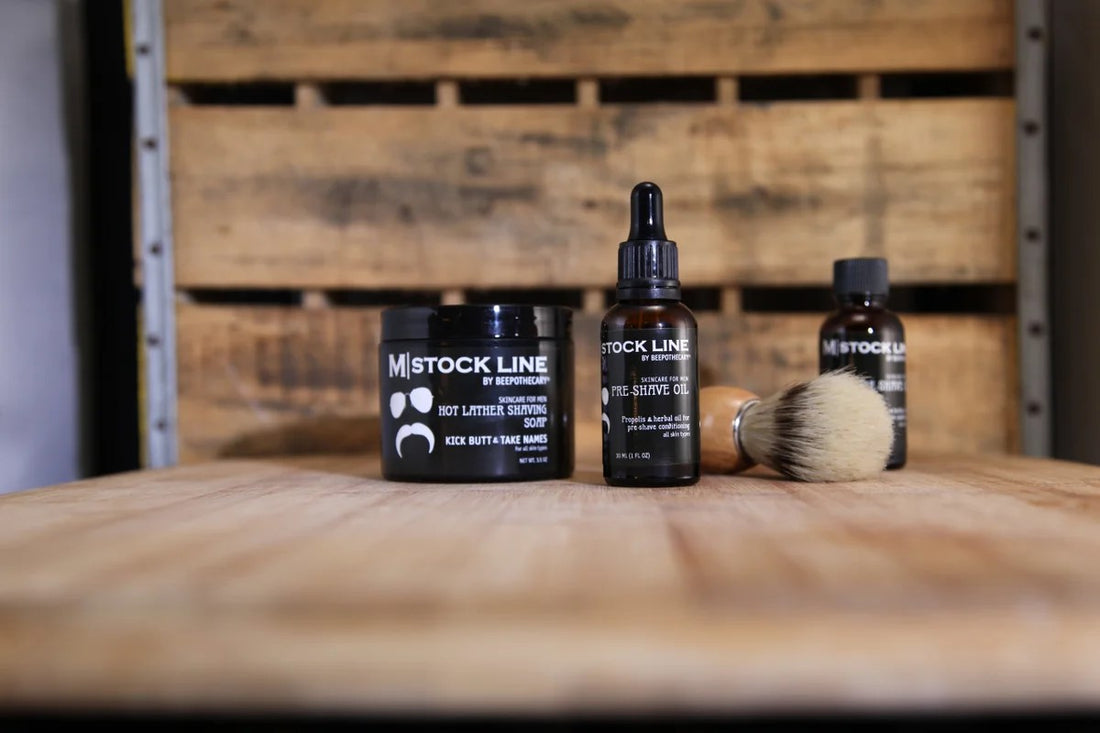 BEEpothecary shave care line including pre-shave oil and shaving soap displayed on a wooden table.